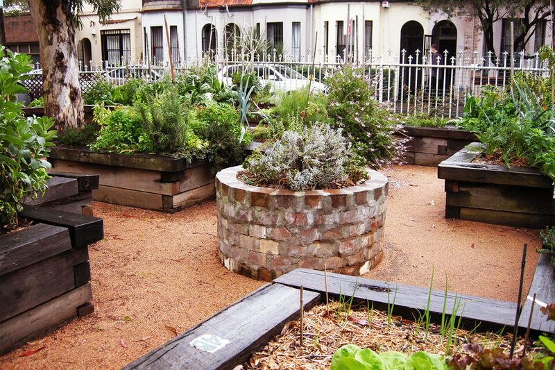 Suburban home with established planted garden beds and shrubs