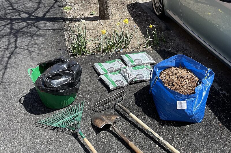 Garden care tools with bags of compost and mulch ready for use